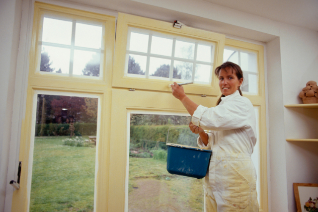 Interior painter with paint brush and paint bucket